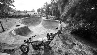 A skateboarder about to skate a pool.
