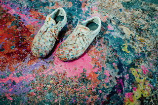 A pair of shoes smothered in resin in a surfboard factory.