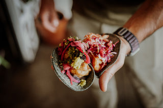 A man holding tacos.